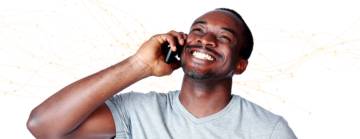 image of a man smiling whilst talking on the phone