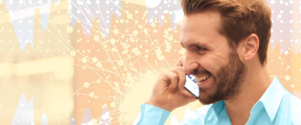 image of a smiling man listening to good on-hold music on his phone